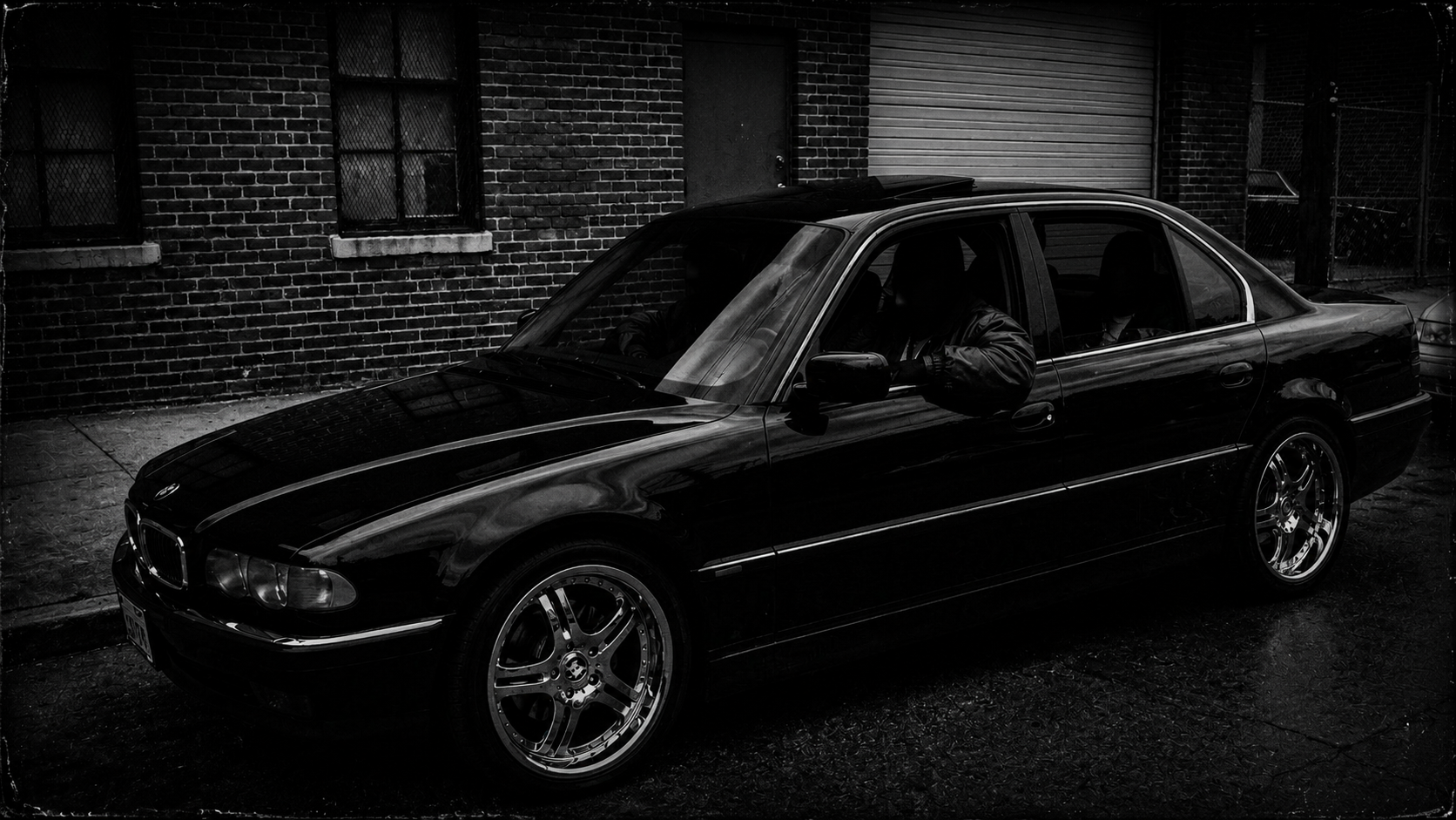RUN-GPT — black BMW 7-series sedan portrait, garage door behind